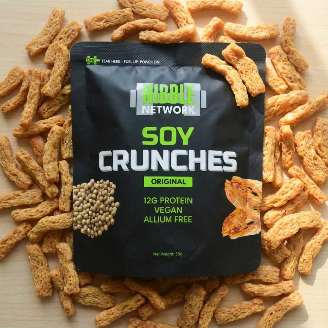 Nibble Network Soy Crunches Original packaging surrounded by crunches on a light background