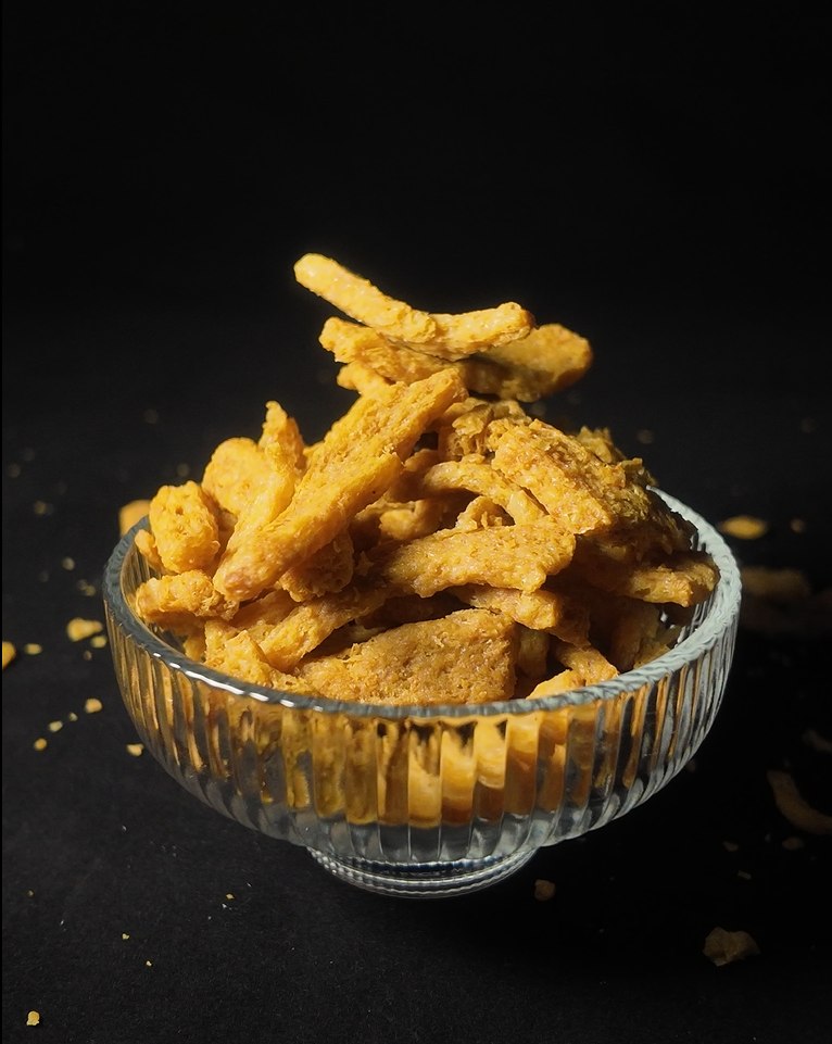 A photograph of Soy Crunches in a glass bowl with a black background
